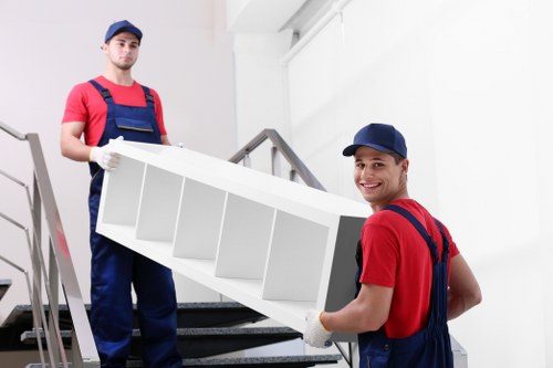 Removal van and moving team in a Berrylands residential street