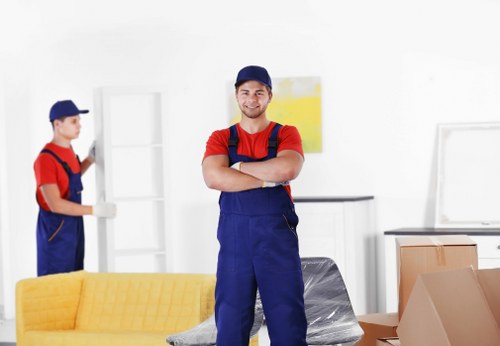 Removal van and movers loading household items in Berrylands