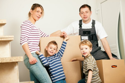 Local movers handling furniture on a residential street in Berrylands