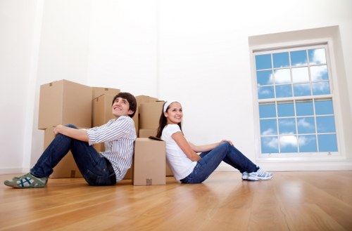 Loading household furniture into a van in Berrylands