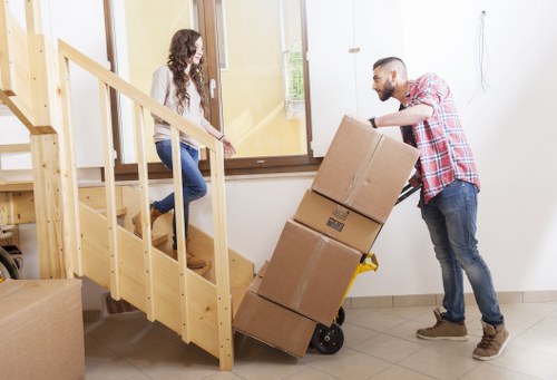Removal team preparing furniture for loading at a Berrylands home