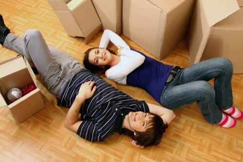 Packed moving boxes and furniture in a Berrylands home
