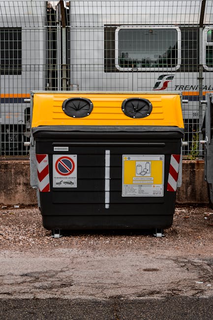 A black litter bin with a green graphic and white text reading 'Litter Stops Here' is positioned on a tiled floor next to a white tiled wall with green and black stripe accents. To the right of the bi